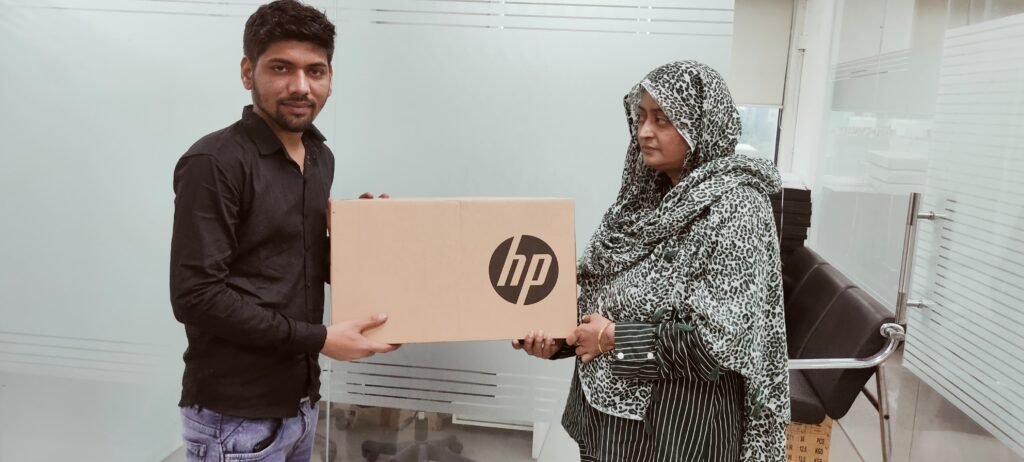 giving laptops to students of rms business school